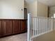 Hallway showcasing a wooden built-in cabinet, white railing and carpeted floor at 7788 Soda Canyon St, Las Vegas, NV 89139