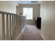 Upper hallway with carpet, railing, window and dark wood cabinet at 7788 Soda Canyon St, Las Vegas, NV 89139