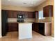 A full kitchen featuring dark wood cabinetry, granite countertops, and stainless steel appliances at 7788 Soda Canyon St, Las Vegas, NV 89139