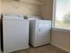 View of laundry room with standard washer and dryer next to window at 7788 Soda Canyon St, Las Vegas, NV 89139