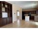 Living room with tile flooring, built in bookshelves, and a view into the kitchen at 7788 Soda Canyon St, Las Vegas, NV 89139