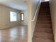 Open-concept living room featuring tile flooring, and a carpeted staircase at 7788 Soda Canyon St, Las Vegas, NV 89139
