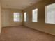 Living room with carpet flooring, lots of windows, and a white front door at 7788 Soda Canyon St, Las Vegas, NV 89139