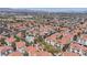 High angle aerial view showcasing community residences with lush green spaces and a distant mountain backdrop at 7905 Idledale Ct # 102, Las Vegas, NV 89145