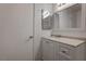 Clean bathroom with white cabinets, and a large mirror above the sink at 7905 Idledale Ct # 102, Las Vegas, NV 89145