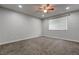 Neutral bedroom featuring a ceiling fan and a bright window at 7905 Idledale Ct # 102, Las Vegas, NV 89145