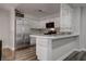 Modern kitchen with stainless steel appliances, white cabinets and breakfast bar at 7905 Idledale Ct # 102, Las Vegas, NV 89145