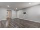 Open floor plan living room featuring wood floors and neutral walls at 7905 Idledale Ct # 102, Las Vegas, NV 89145