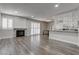 Spacious living room featuring fireplace, wood floors and plantation shutters at 7905 Idledale Ct # 102, Las Vegas, NV 89145