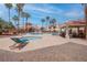 Resort-style pool area with a spa, lounge chairs, and palm trees providing shade at 7905 Idledale Ct # 102, Las Vegas, NV 89145