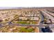 Extensive suburban community features sidewalks and green spaces with city skyline in the distance at 8137 Cape Flattery Ave, Las Vegas, NV 89147