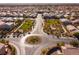 Neighborhood aerial view of landscaped traffic circle with residential homes and mature trees at 8137 Cape Flattery Ave, Las Vegas, NV 89147