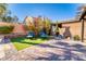 Serene backyard retreat with well-manicured lawn, mature landscaping, and a charming patio area at 8137 Cape Flattery Ave, Las Vegas, NV 89147