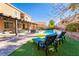 Stunning backyard featuring a pool, patio, outdoor seating, and lush landscaping at 8137 Cape Flattery Ave, Las Vegas, NV 89147