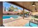 Expansive backyard with a pool, spa, covered patio, and ample space for outdoor living at 8137 Cape Flattery Ave, Las Vegas, NV 89147