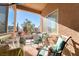 Cozy balcony with cushioned seating and views of the neighborhood trees and sky at 8137 Cape Flattery Ave, Las Vegas, NV 89147
