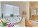 Bright bathroom featuring a soaking tub, shower, and window with natural light at 8137 Cape Flattery Ave, Las Vegas, NV 89147