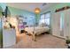 Cozy bedroom with light green walls, natural light, and minimalistic furnishings at 8137 Cape Flattery Ave, Las Vegas, NV 89147