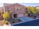 Exterior elevation of a three car garage two-story home on landscaped lot in suburban neighborhood at 8137 Cape Flattery Ave, Las Vegas, NV 89147