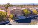 Street view of a two story home with a three car garage and mature landscaping at 8137 Cape Flattery Ave, Las Vegas, NV 89147