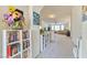 Hallway with bookshelves leading to living room with a ceiling fan and neutral decor at 8137 Cape Flattery Ave, Las Vegas, NV 89147