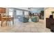 Bright open-concept area, featuring comfortable sofas, open to the kitchen with tile flooring at 8137 Cape Flattery Ave, Las Vegas, NV 89147