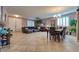Spacious living room featuring tile flooring, a comfortable sectional sofa, and a dining area at 8137 Cape Flattery Ave, Las Vegas, NV 89147