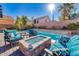 Beautiful backyard pool with a fire pit and comfortable seating, perfect for entertaining at 8137 Cape Flattery Ave, Las Vegas, NV 89147