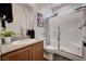 Well-lit bathroom featuring a glass-enclosed shower, modern fixtures, and a vanity with granite countertop at 8164 Golden Cholla Ave, Las Vegas, NV 89179