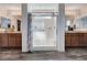 Bathroom featuring double sinks, granite countertops, and a glass-enclosed shower with tiled walls at 8164 Golden Cholla Ave, Las Vegas, NV 89179
