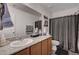 Bathroom featuring granite countertops, a large mirror, and a shower with a decorative curtain at 8164 Golden Cholla Ave, Las Vegas, NV 89179