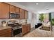 Granite counters and stainless appliances adorn this well-appointed kitchen at 8164 Golden Cholla Ave, Las Vegas, NV 89179