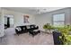 Bright living room with a black velvet sofa, accent pillows, and plants, creating a cozy atmosphere at 8164 Golden Cholla Ave, Las Vegas, NV 89179