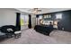 Spacious main bedroom with a dark accent wall, large windows, and cozy furnishings for a relaxing retreat at 8164 Golden Cholla Ave, Las Vegas, NV 89179