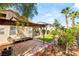 Spacious backyard with a pergola, stone patio, and garden beds, perfect for outdoor activities and relaxation at 8317 Fritzen Ave, Las Vegas, NV 89131
