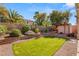 Green backyard with mature trees, a play structure, and privacy fencing, perfect for Gathering activities at 8317 Fritzen Ave, Las Vegas, NV 89131