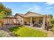 Large backyard with a covered patio, spacious lawn, and mature trees, ideal for recreation and relaxation at 8317 Fritzen Ave, Las Vegas, NV 89131