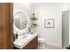 Modern bathroom featuring a vanity with sink, illuminated mirror, and a glass-enclosed shower at 8317 Fritzen Ave, Las Vegas, NV 89131