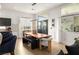 Dining area features modern table with bench seating, contemporary lighting, and natural light from large windows at 8317 Fritzen Ave, Las Vegas, NV 89131