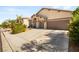 Exterior shot of a one story home showing the ample driveway and desert landscaping at 8317 Fritzen Ave, Las Vegas, NV 89131