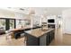 Open concept kitchen features a large island, modern lighting, and seamless access to the outdoor patio at 8317 Fritzen Ave, Las Vegas, NV 89131