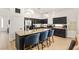 Modern kitchen features a granite island with seating, stainless steel appliances, and sleek design at 8317 Fritzen Ave, Las Vegas, NV 89131