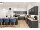 A kitchen boasts a central island with seating, modern pendant lighting, and updated stainless steel appliances at 8317 Fritzen Ave, Las Vegas, NV 89131