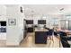 A bright kitchen features dark cabinetry, stainless appliances, and a spacious island with seating at 8317 Fritzen Ave, Las Vegas, NV 89131