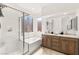Bathroom features double sinks, wood cabinets, large tub and glass enclosed shower at 8317 Fritzen Ave, Las Vegas, NV 89131