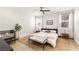 Bright main bedroom features neutral walls, wood-look floors, ceiling fan, and plentiful natural light at 8317 Fritzen Ave, Las Vegas, NV 89131