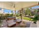 Relaxing covered patio with outdoor seating, a fan, and lush landscaping for peaceful outdoor living at 8317 Fritzen Ave, Las Vegas, NV 89131