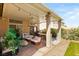 Charming covered patio featuring cozy seating, a grill, and a view of the well-maintained lawn at 8317 Fritzen Ave, Las Vegas, NV 89131