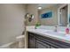 Modern half bathroom with stylish vanity, decorative wall art, and contemporary fixtures at 9469 Coral Shine Ct, Las Vegas, NV 89123