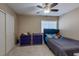 Comfortable bedroom with light-colored walls, a ceiling fan, and an adjacent closet at 9469 Coral Shine Ct, Las Vegas, NV 89123